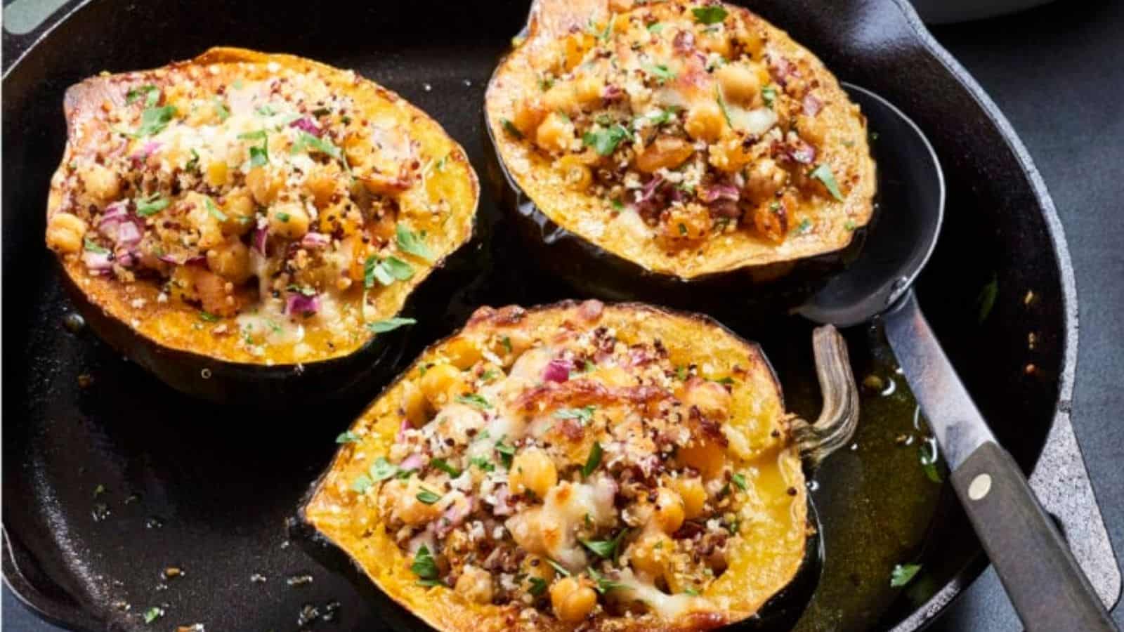 3 pieces of quinoa stuffed acorn squash in a pan.