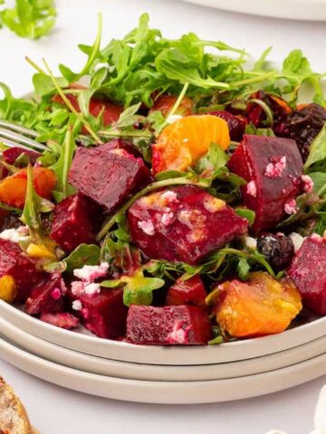 Roasted Beet Salad on a stack of plates.