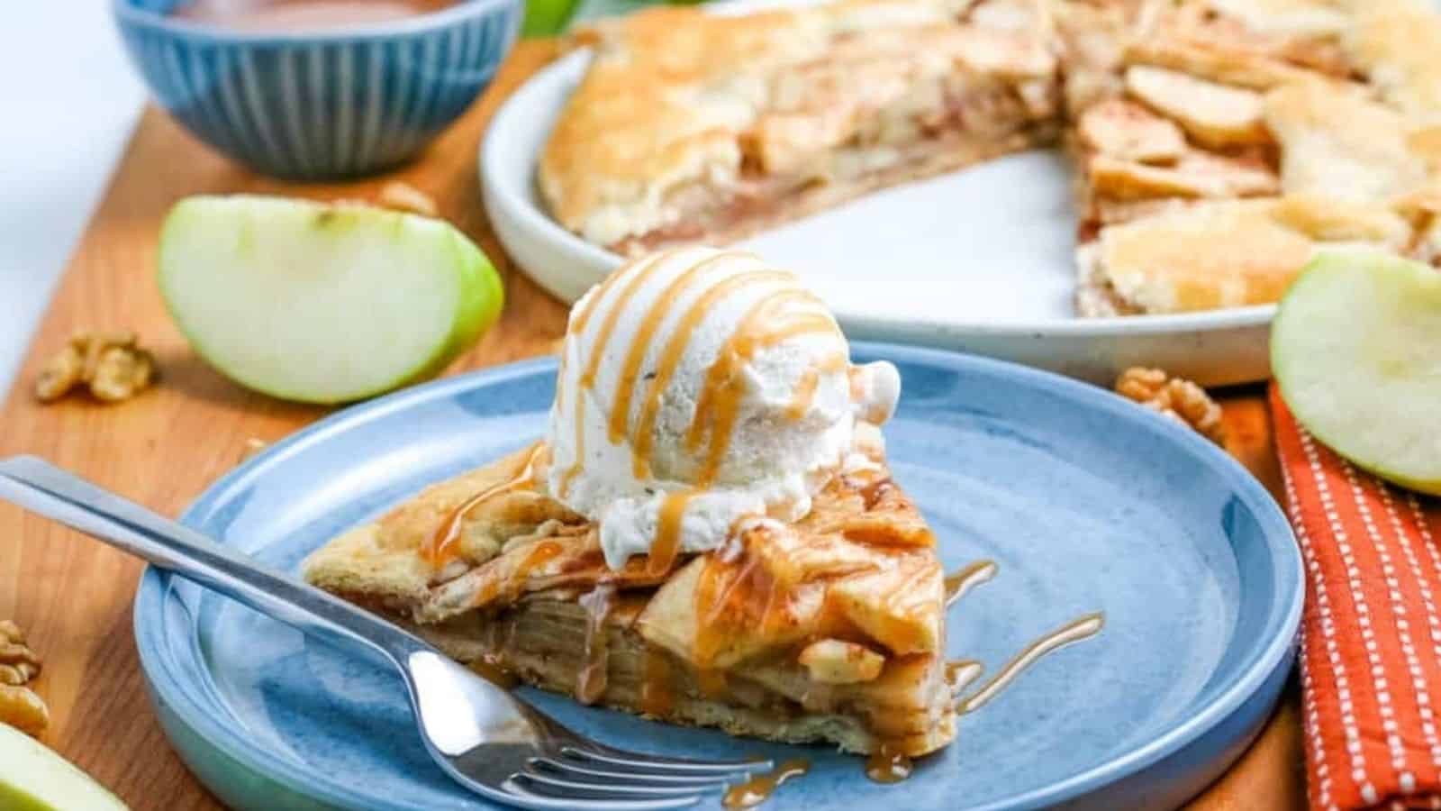 A slice of apple galette with ice cream on a plate.