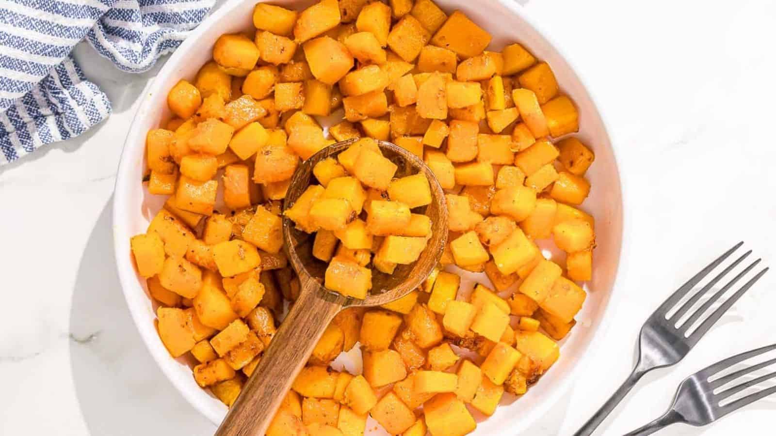 Sauteed butternut squash in a stainless steel pan.