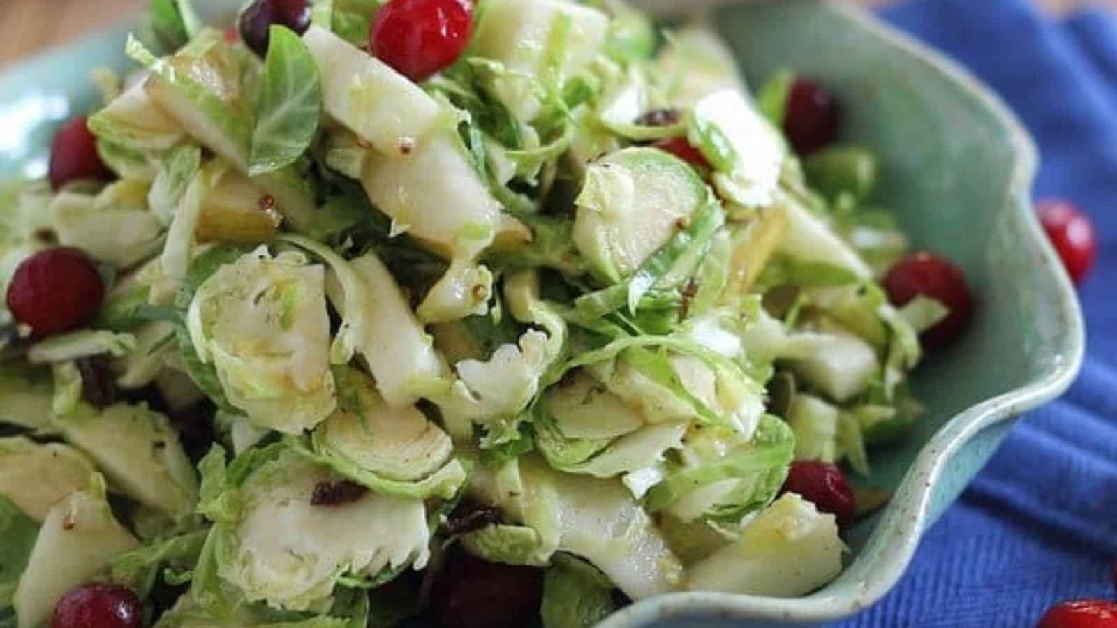 Close-up image of shaved brussels sprouts fruit salad in a salad bowl.