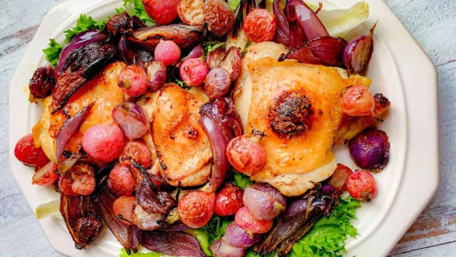 Crispy, brown-skinned chicken roasted with shallots and radishes on a sheet pan.