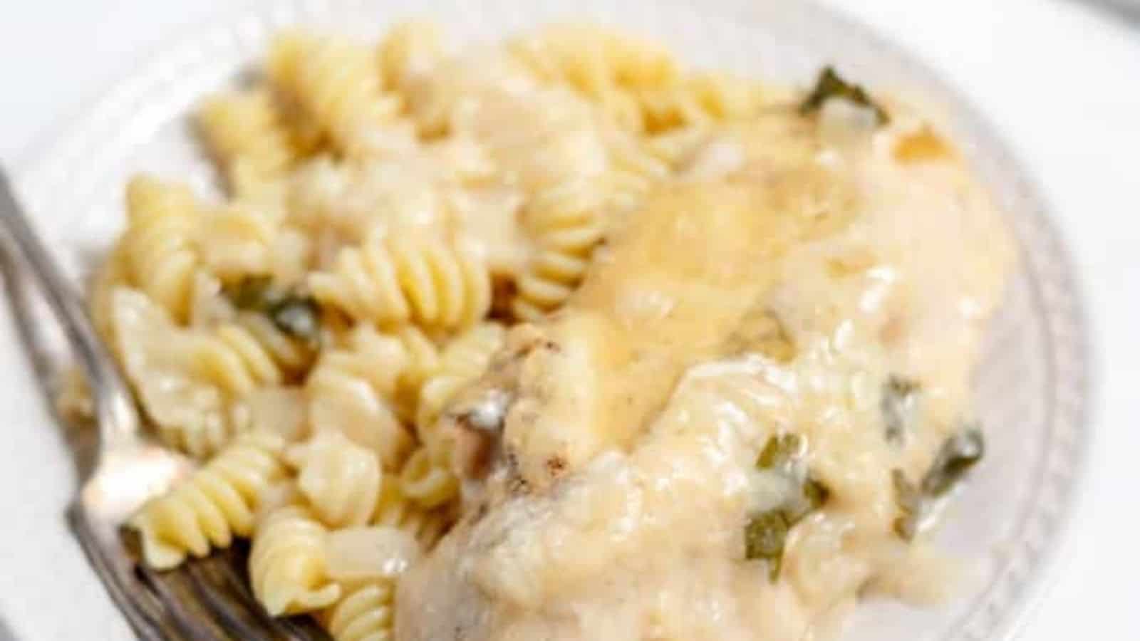 Close-up image of slow cooker garlic parmesan chicken with a fork on a plate.