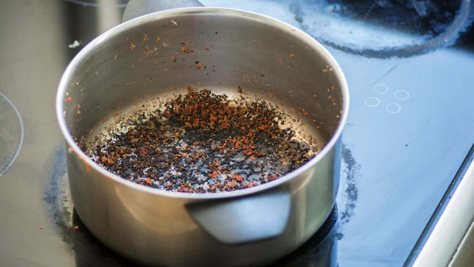 Empty burnt pot with black and red bottom.