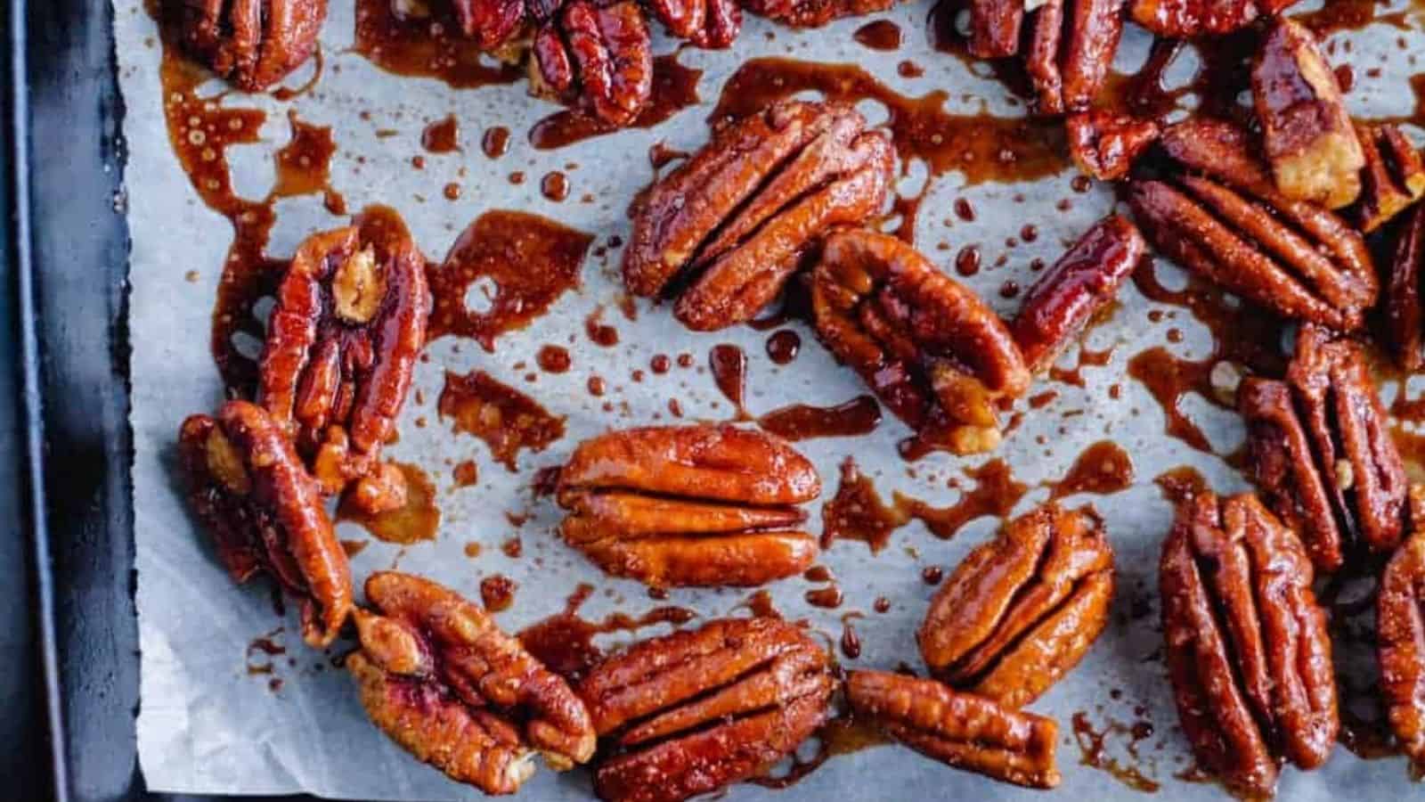 Spicy candied pecans on a baking tray.