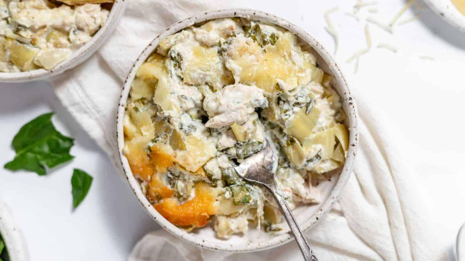 A bowl of Spinach Artichoke Chicken Casserole.