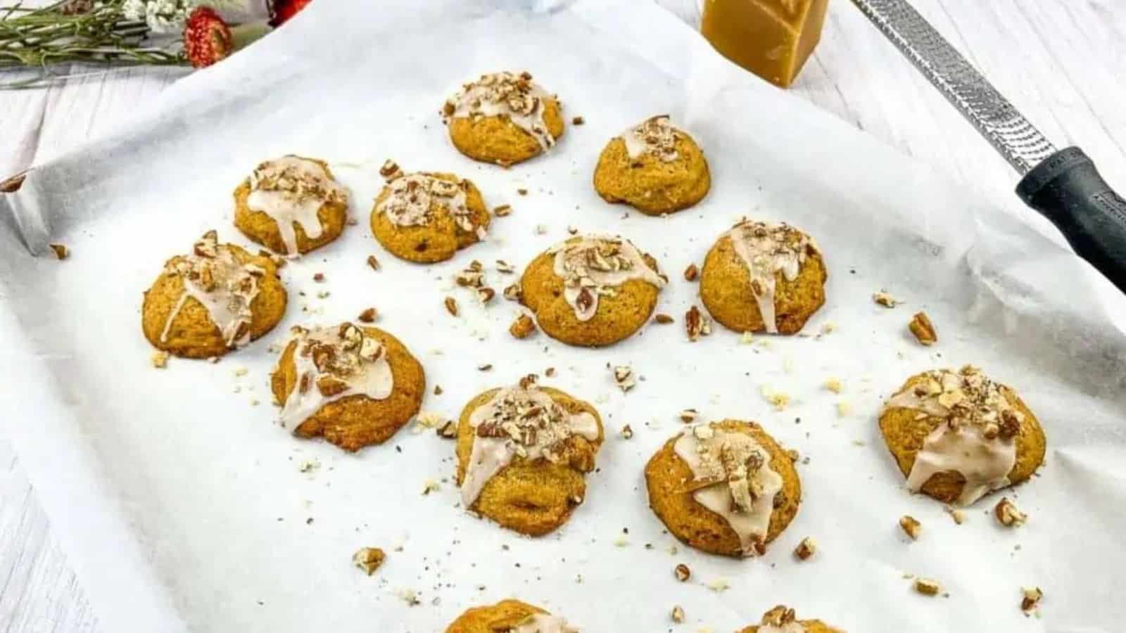 Sweet potato cookies with pecans & maple glaze on a baking tray.