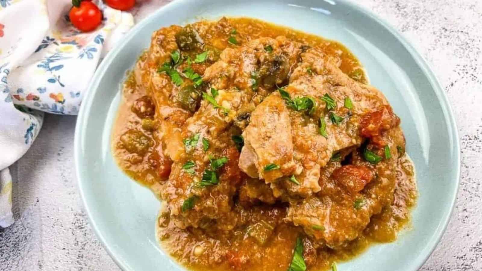 Slow Cooker Swiss Pork Chops on a baby blue serving dish.