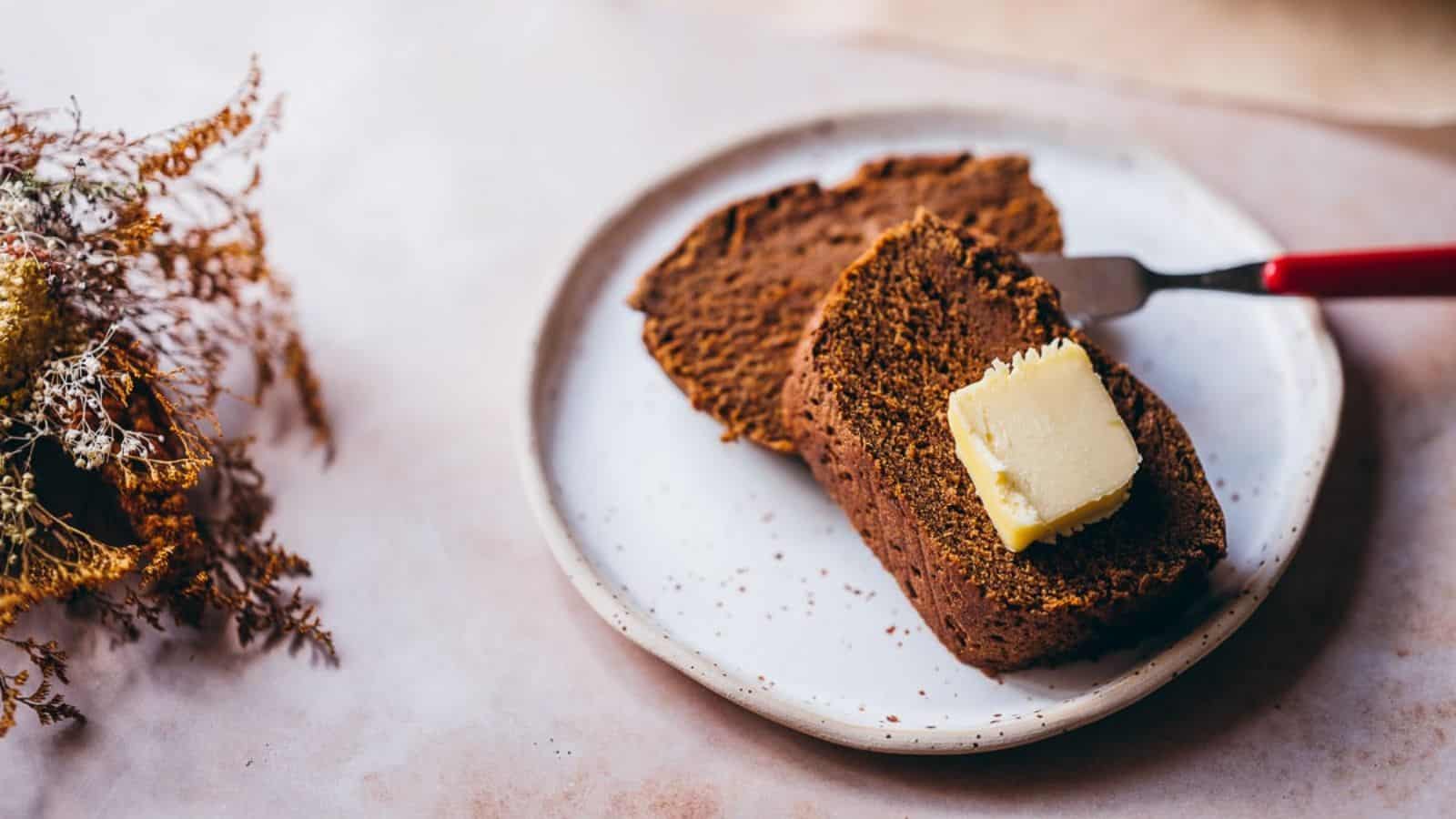 A plate with two slices of Teff Flour Pumpkin Bread.