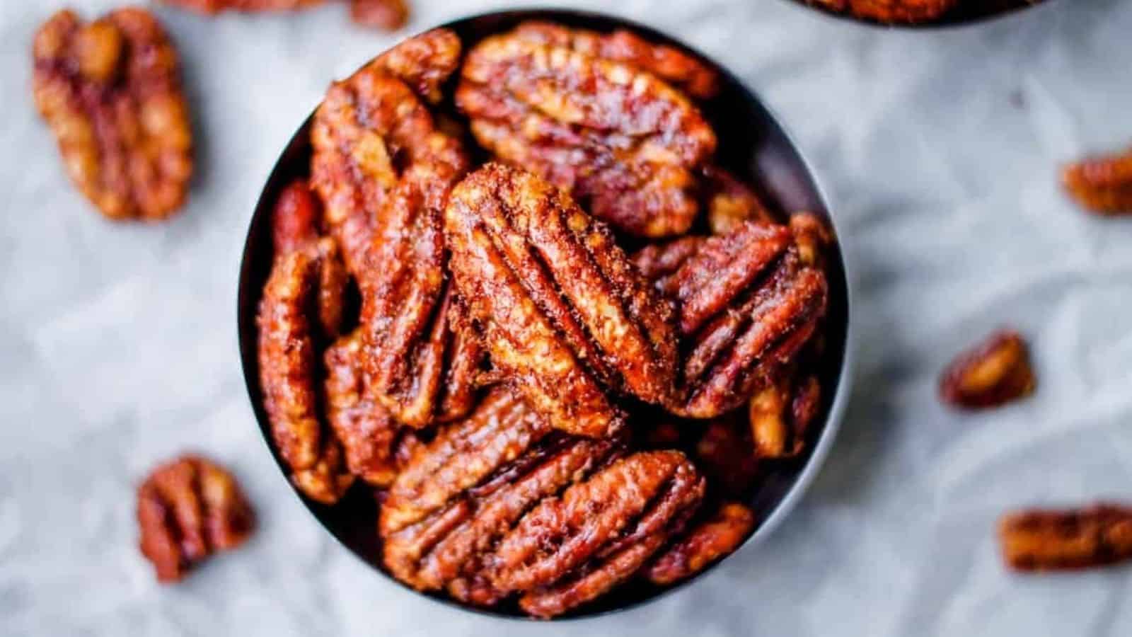 An overhead image of a small dish of texas glazed pecans.