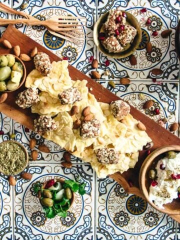 A tray of nuts and a container of natural delights.