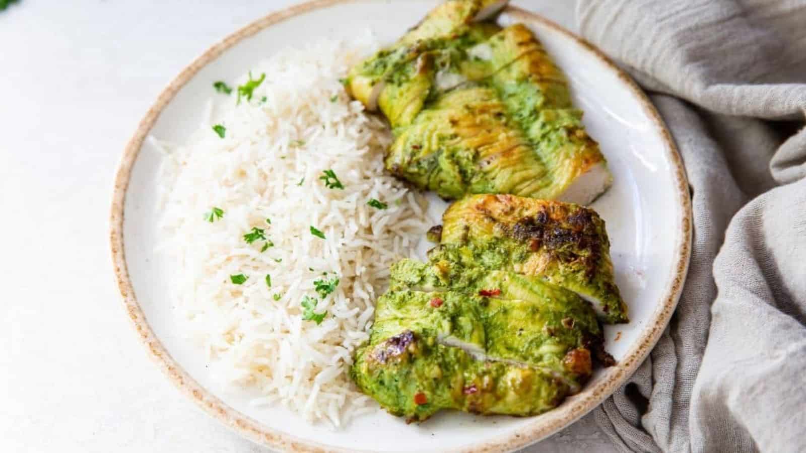 Trader Joe's Pesto Chicken in the Air Fryer on a white plate with white rice and parsley.