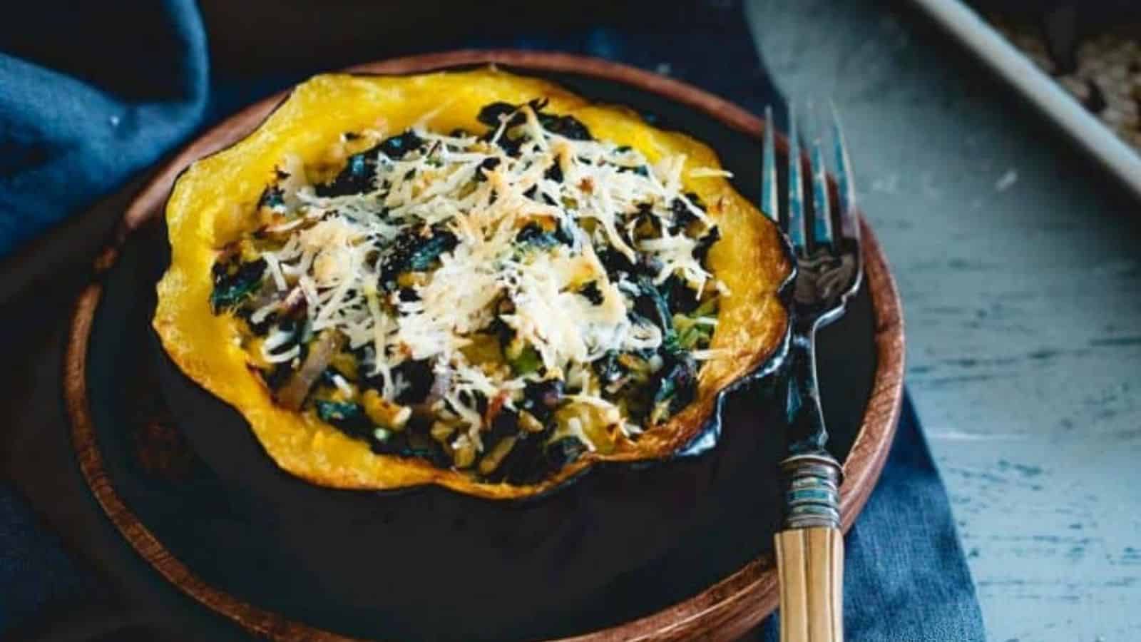 Twice baked kale and pecorino acorn squash on a plate.