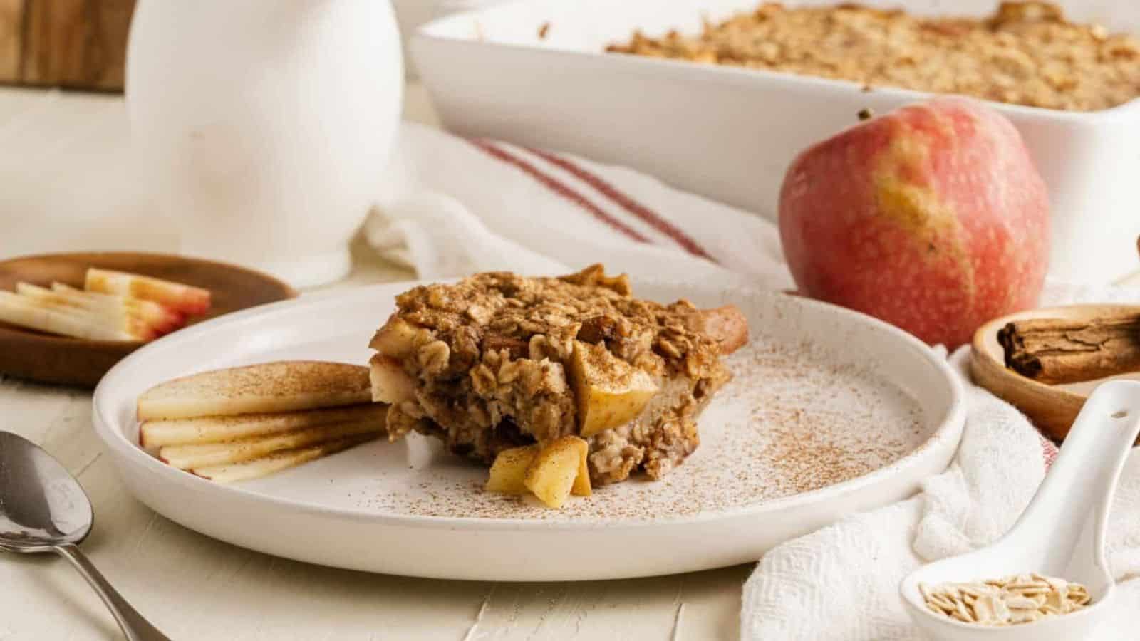 Baked oatmeal with apple and pecans on a plate.