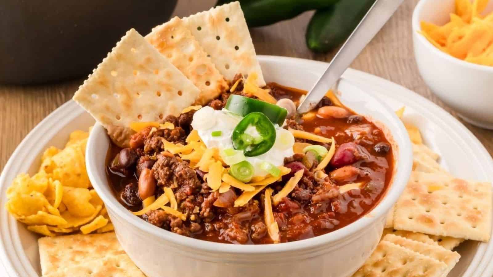 Close-up image of venison choli with crackers in a bowl.