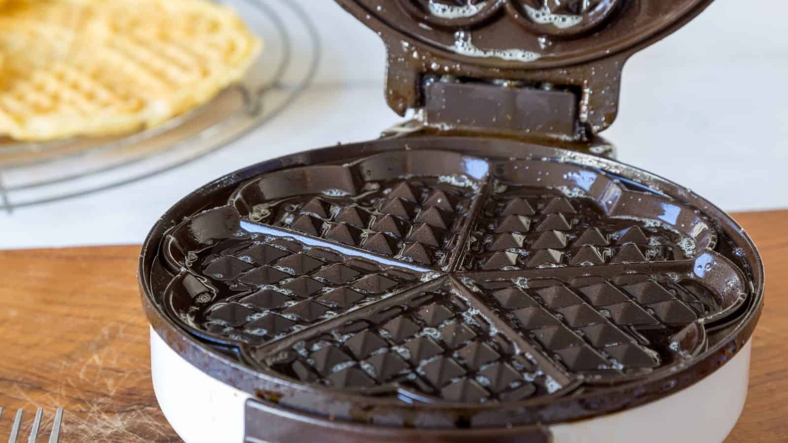 Close-up image of an open waffle maker.