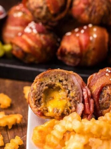 Air fryer bacon wrapped cheeseburger bites with fries.