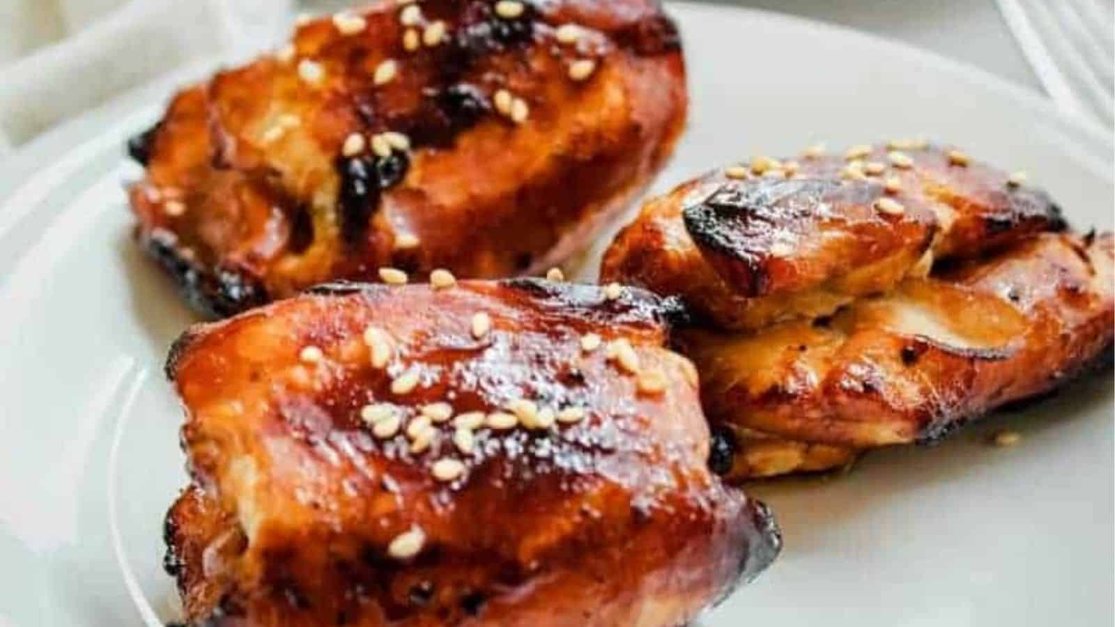 Three pieces air fryer honey soy chicken highs on a plate.