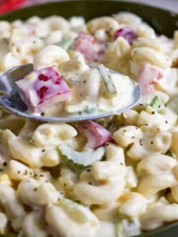 Bowl of Amish macaroni salad with some on a spoon.