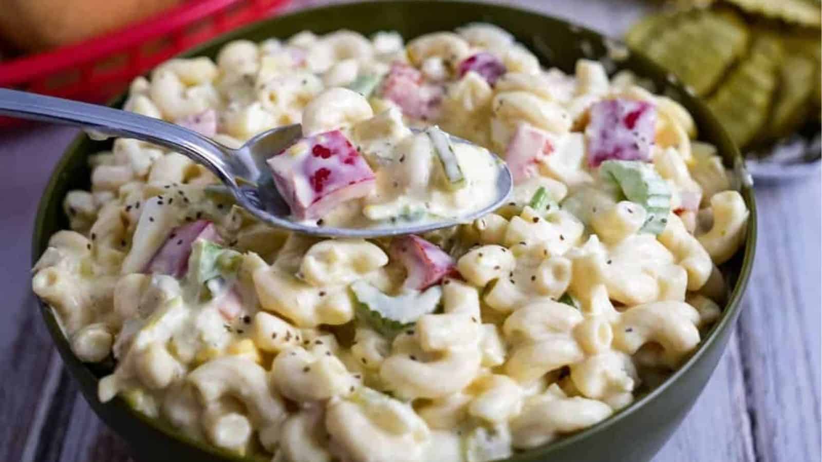 Bowl of Amish macaroni salad with some on a spoon.