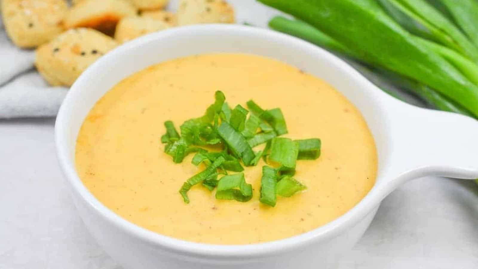 Cheese dip in a white bowl.