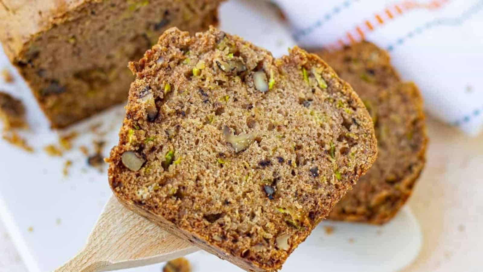 A slice of old-fashioned zucchini bread on a white plate.