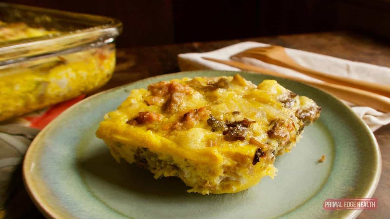 A picture of a portion of keto breakfast casserole on light blue plate.