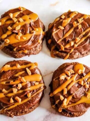 Four pieces of chocolate caramel cookies on the marble surface.