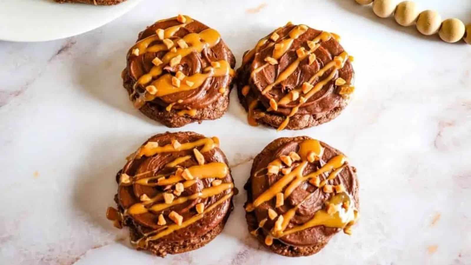 Four pieces of chocolate caramel cookies on the marble surface.