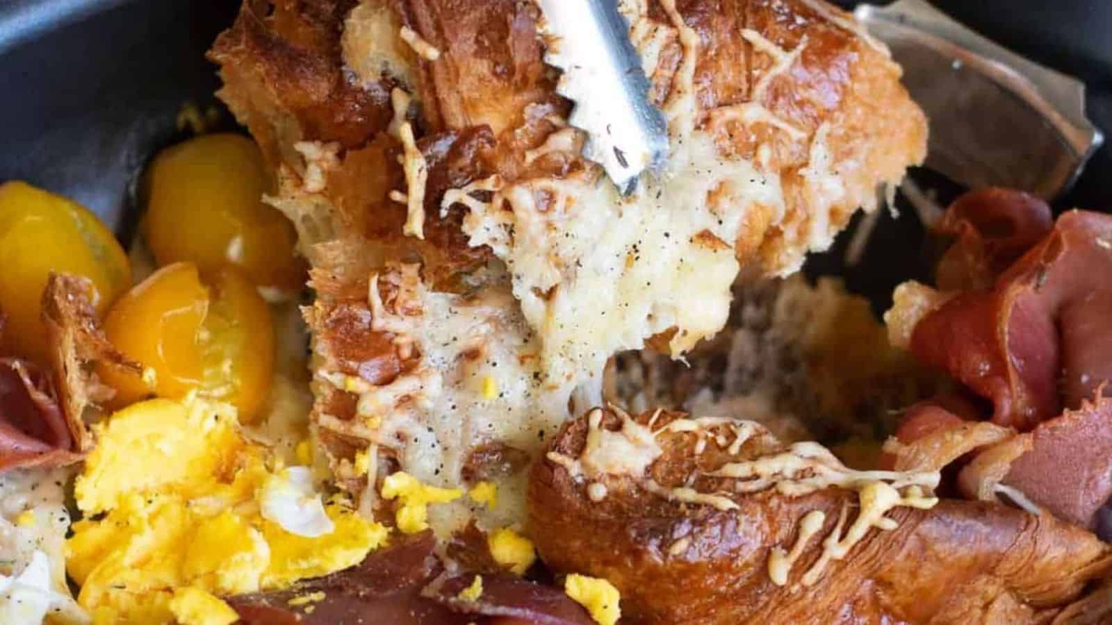 Overhead view of a croissant breakfast casserole in a skillet ready to be baked.