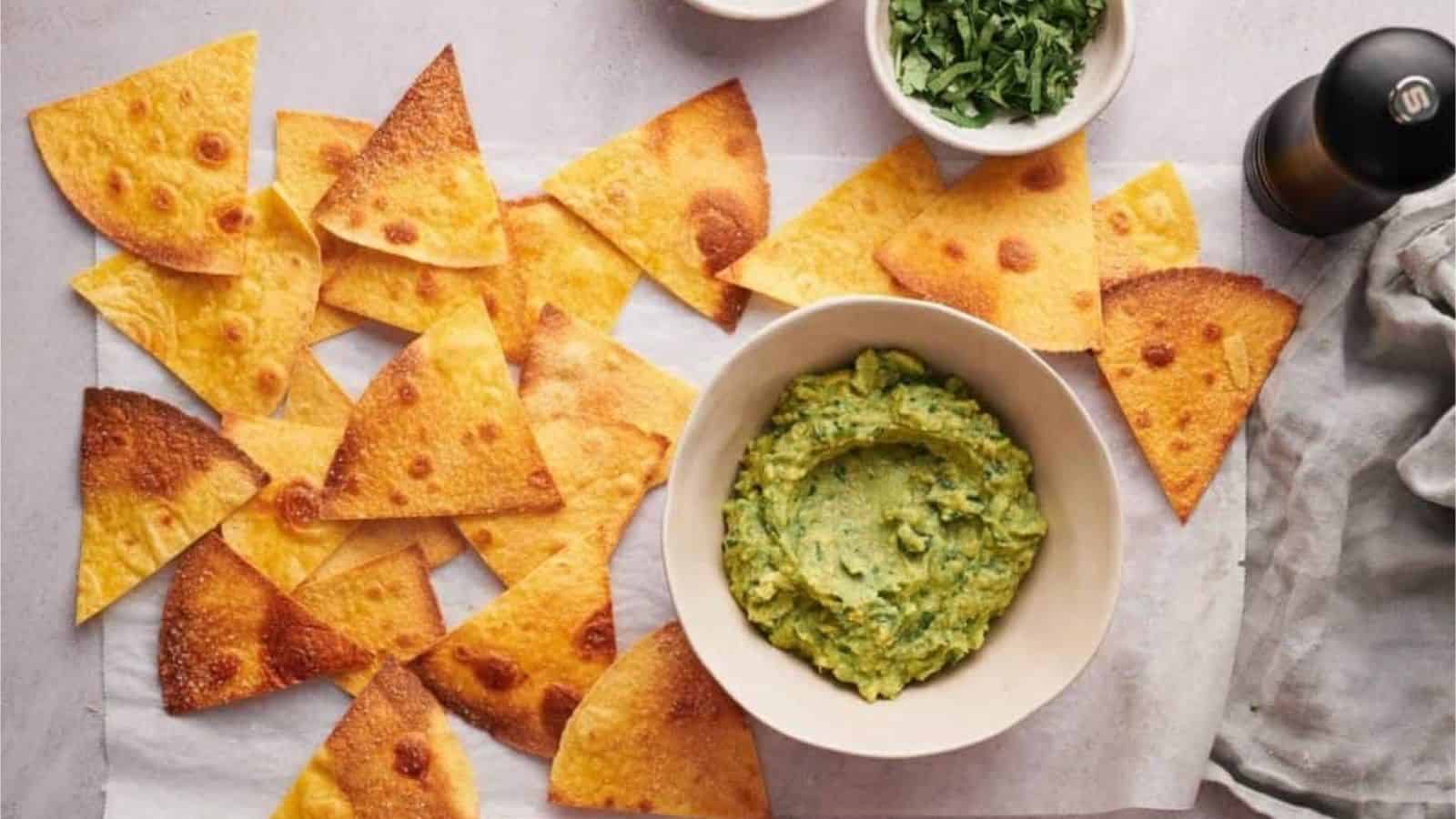 Overhead image of crunchy tortilla chip with dip.