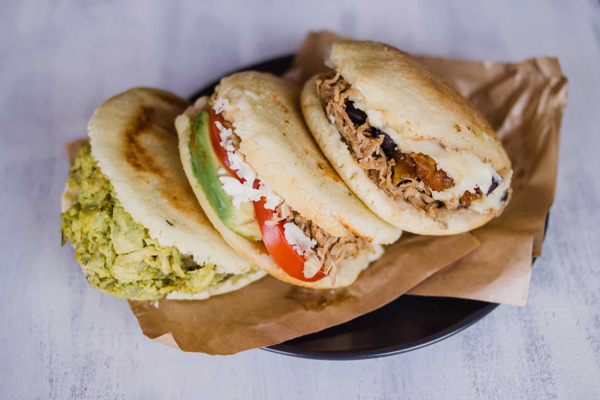 Arepa, a typical food from Venezuela and Colombia, on a white background ready to eat.