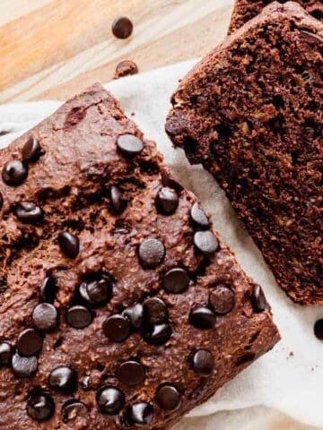 Double chocolate banana bread with chocolate chips sliced on a cutting board.