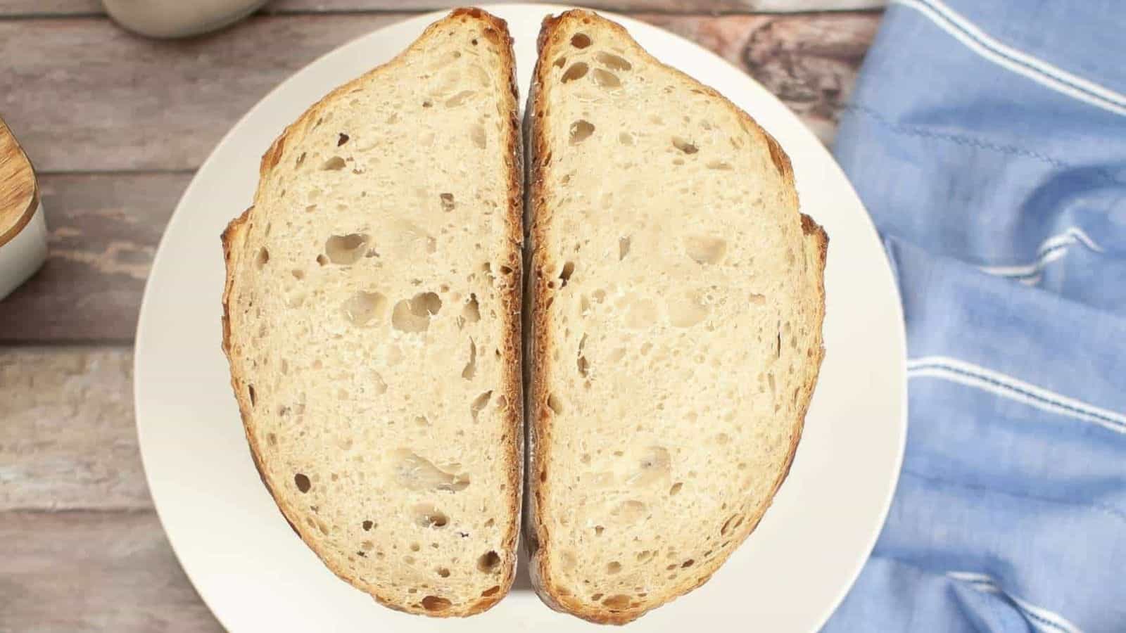 Two pieces of dutch oven sourdough bread on a plate.