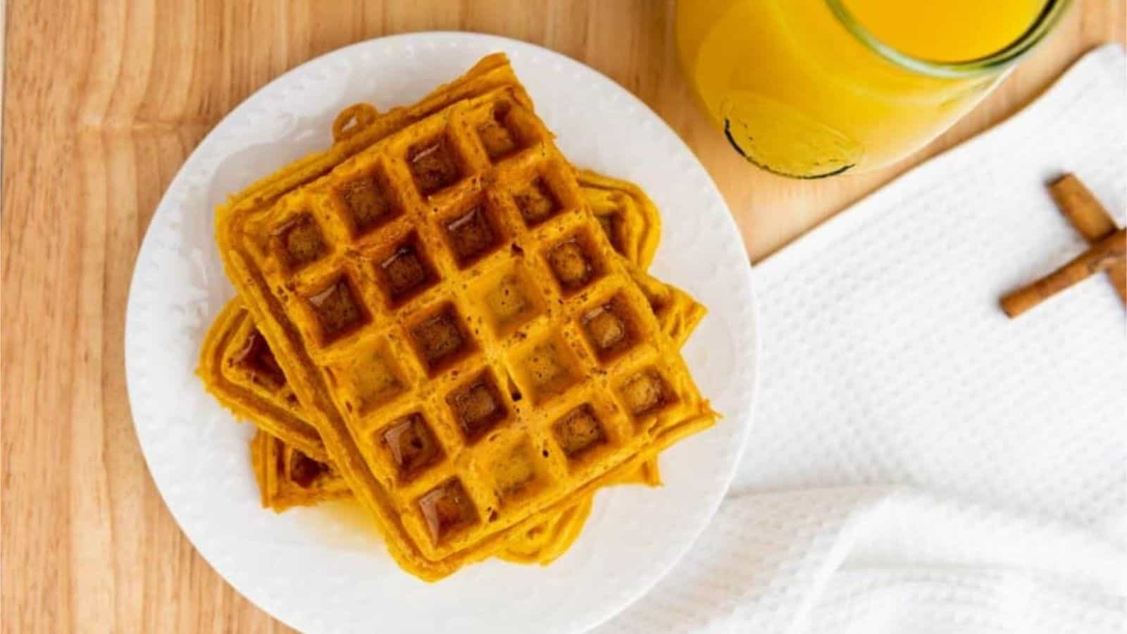 Overrhead image of a stack of easy pumpkin waffles on a plate.