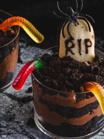 Three halloween graveyard pudding cups.
