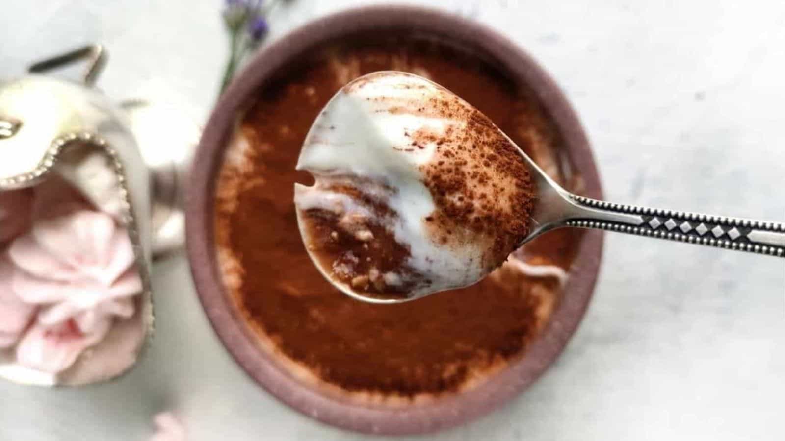 A spoonful of overnight oats tiramisu over a pretty bowl.