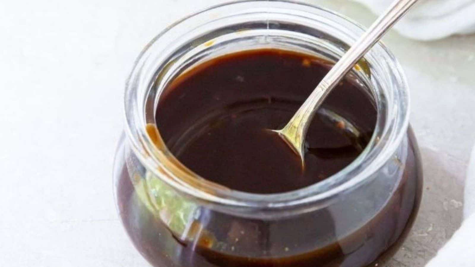 Honey Teriyaki Sauce Recipe (Paleo & Gluten-Free) in a glass jar with a spoon.