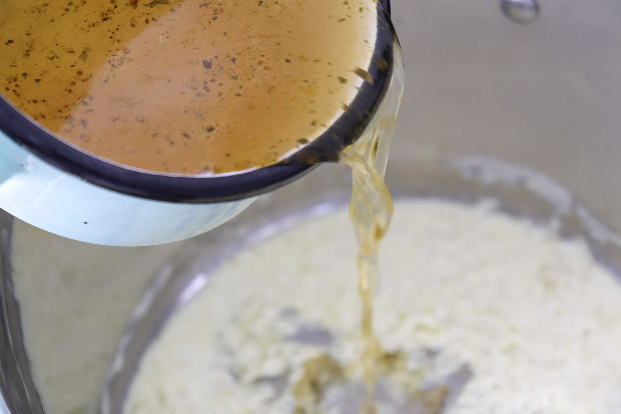 Close-up image of broth being poured.