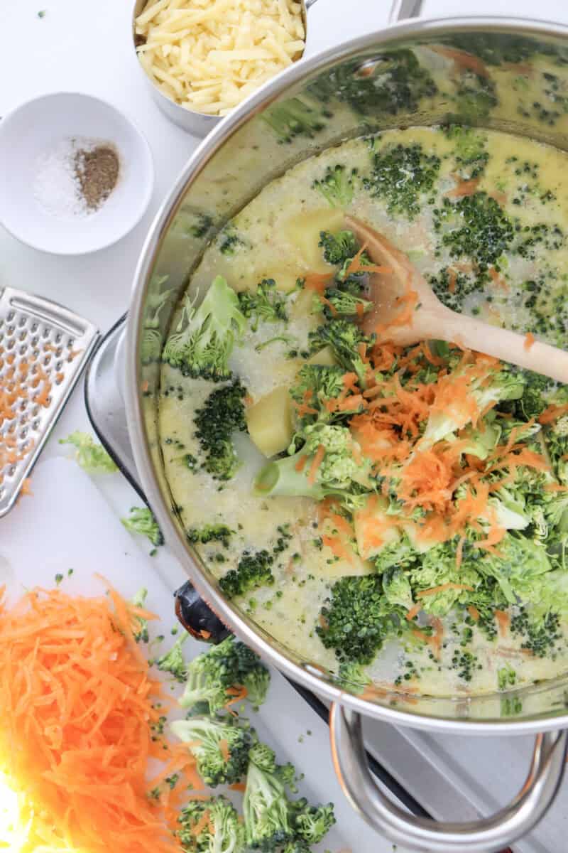 Overhead image of broccoli cheddar soup being cook in a pot.