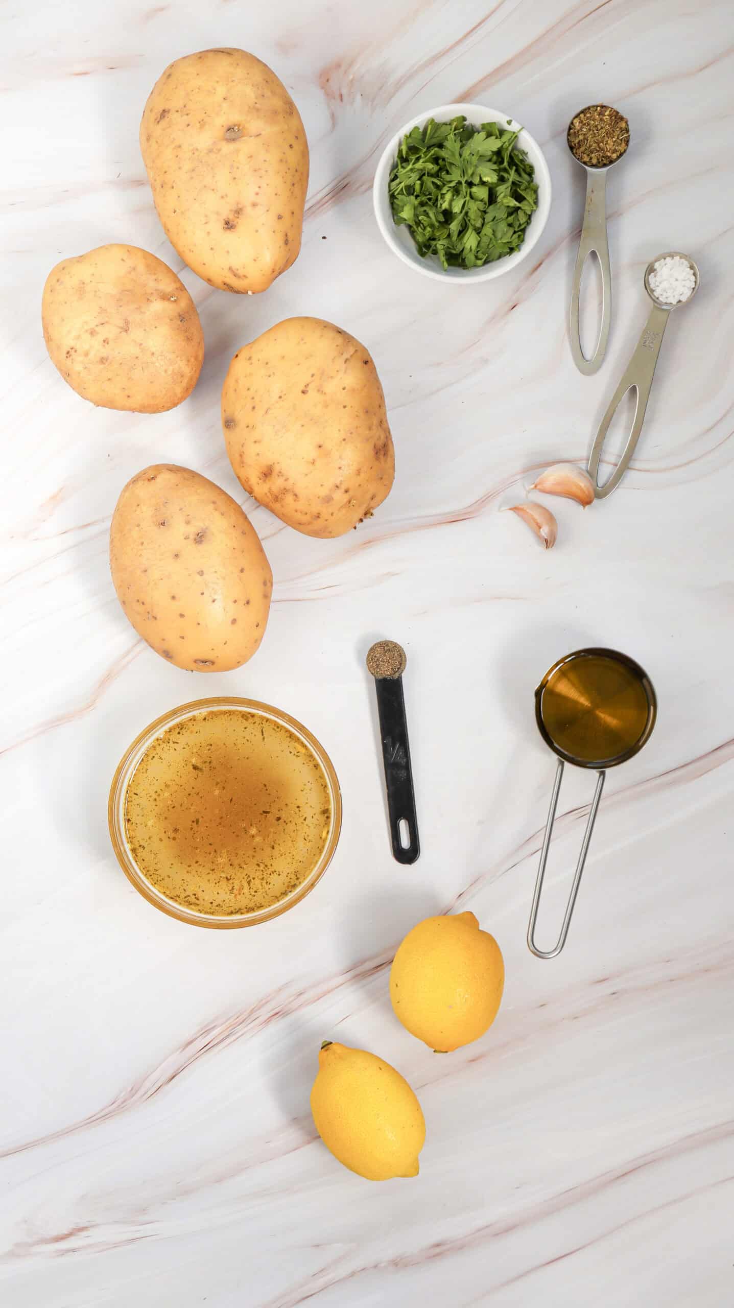 An overhead image of the ingredients of lemon greek potatoes.