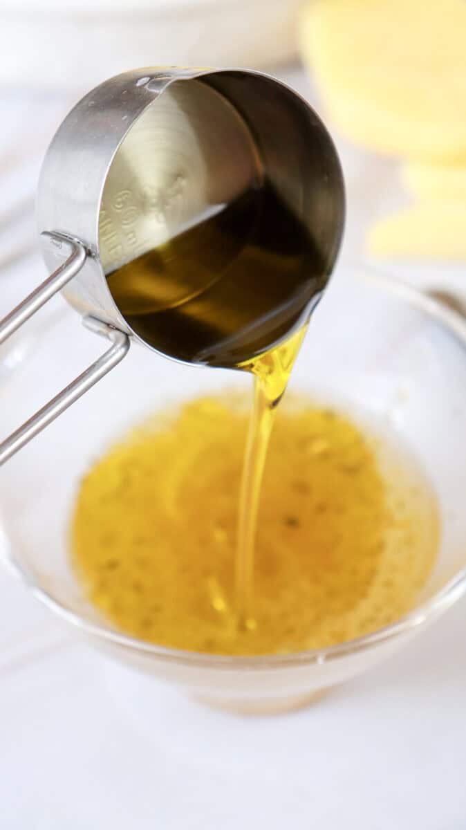 A brown liquid being added in the mixing bowl.