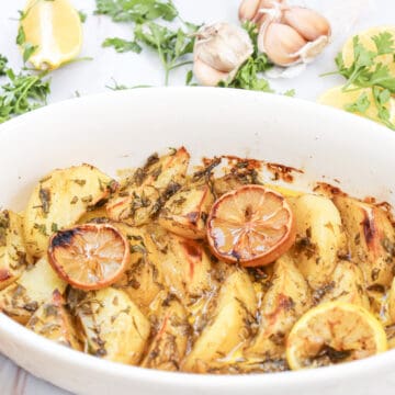 Close-up image of lemon greek potatoes in a dish.