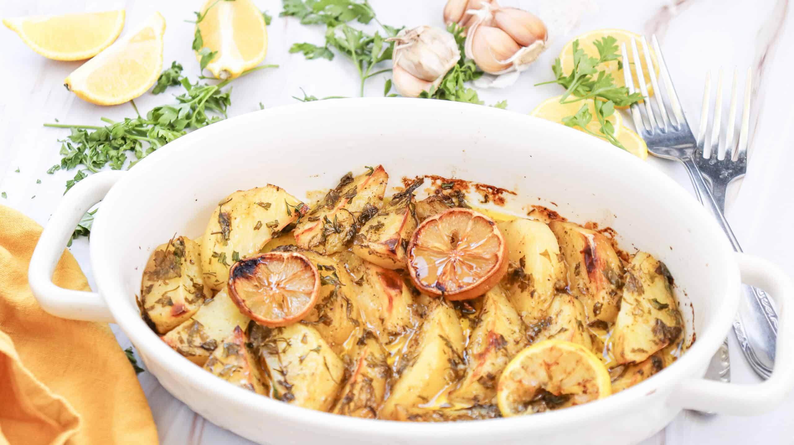 Close-up image of lemon greek potatoes in a dish.