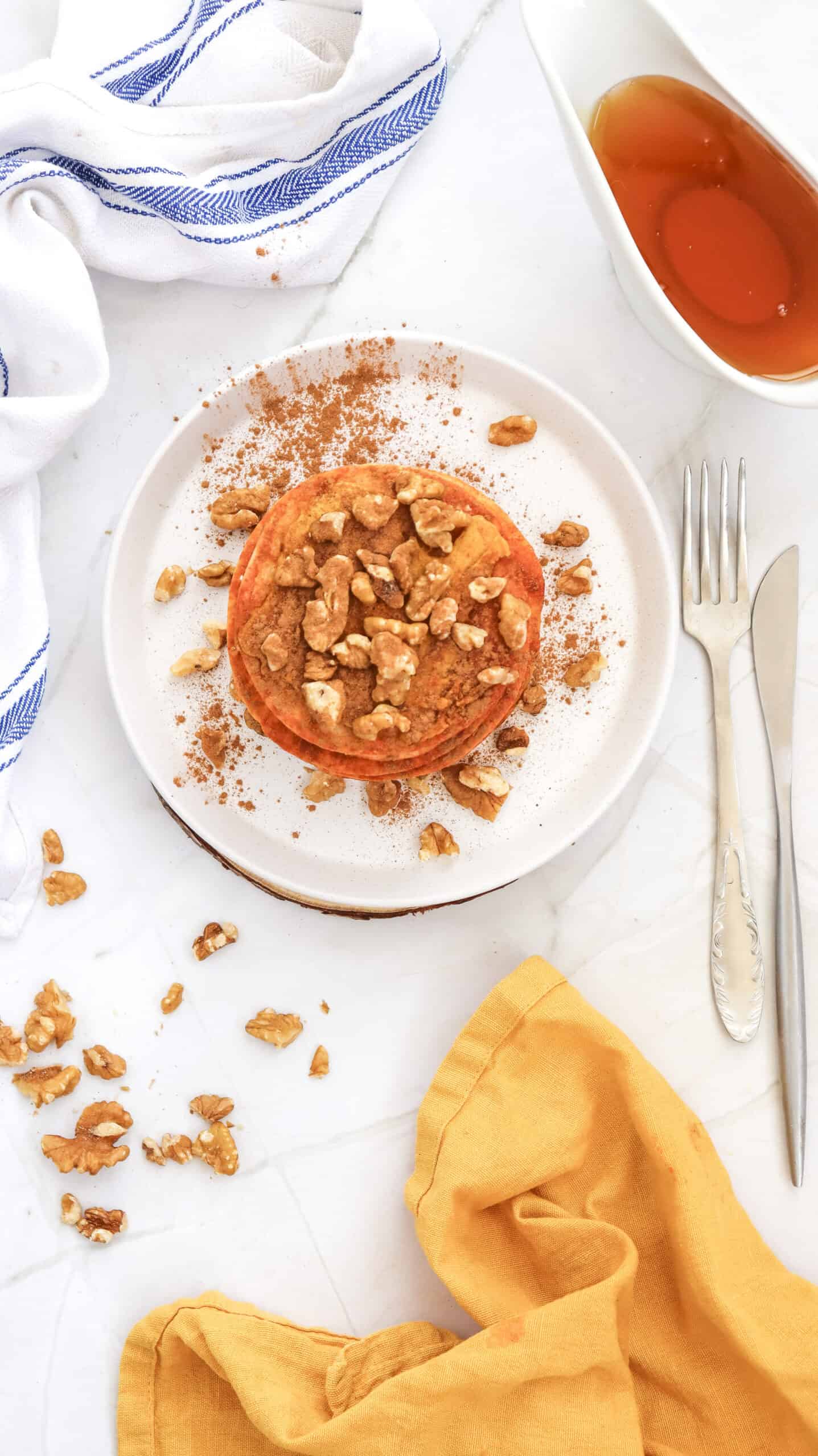 An overhead image of pumpkin pancakes on a plate.