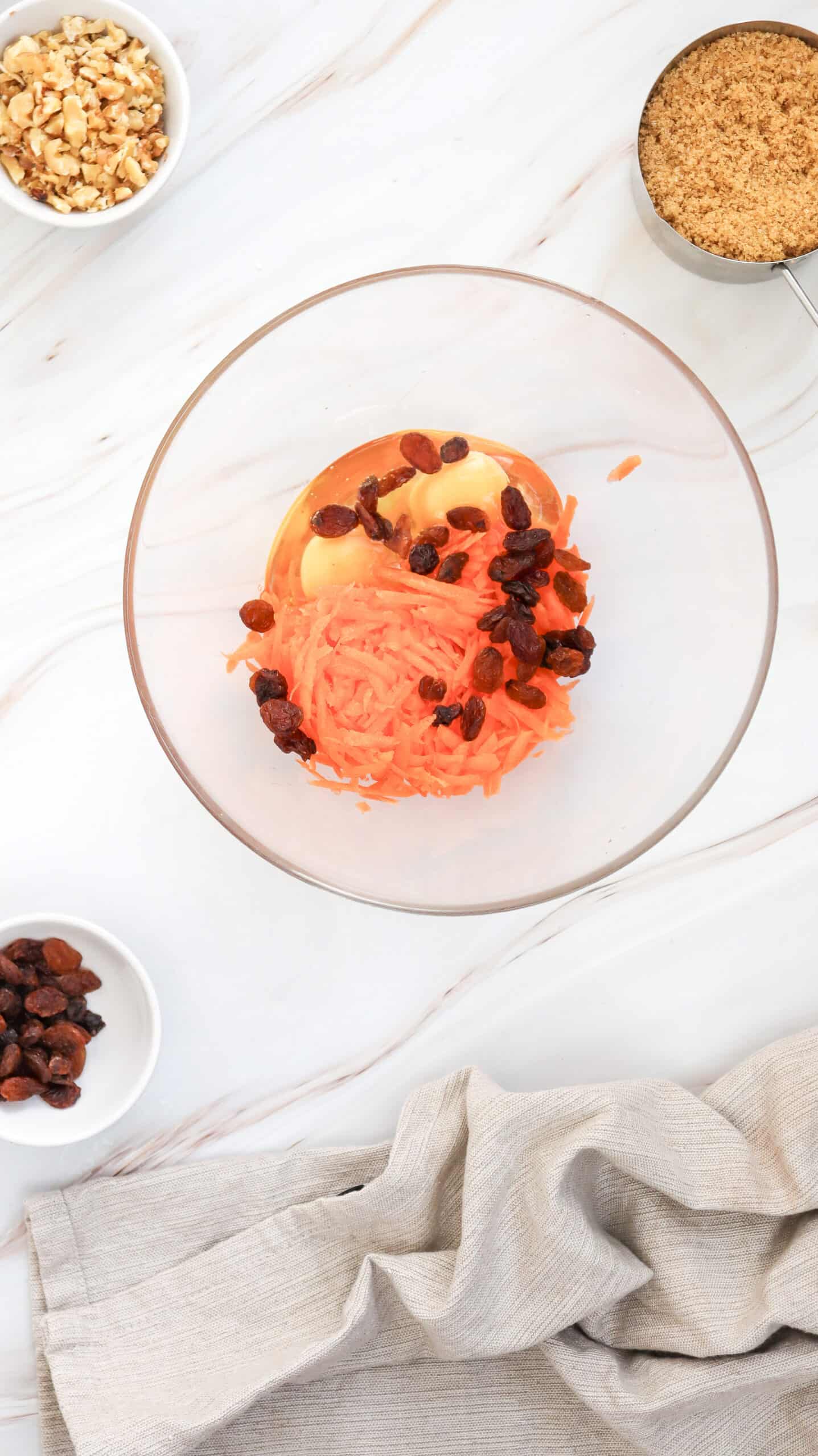 An overhead image of carrot cake muffins ingredients in a mixing bowl.