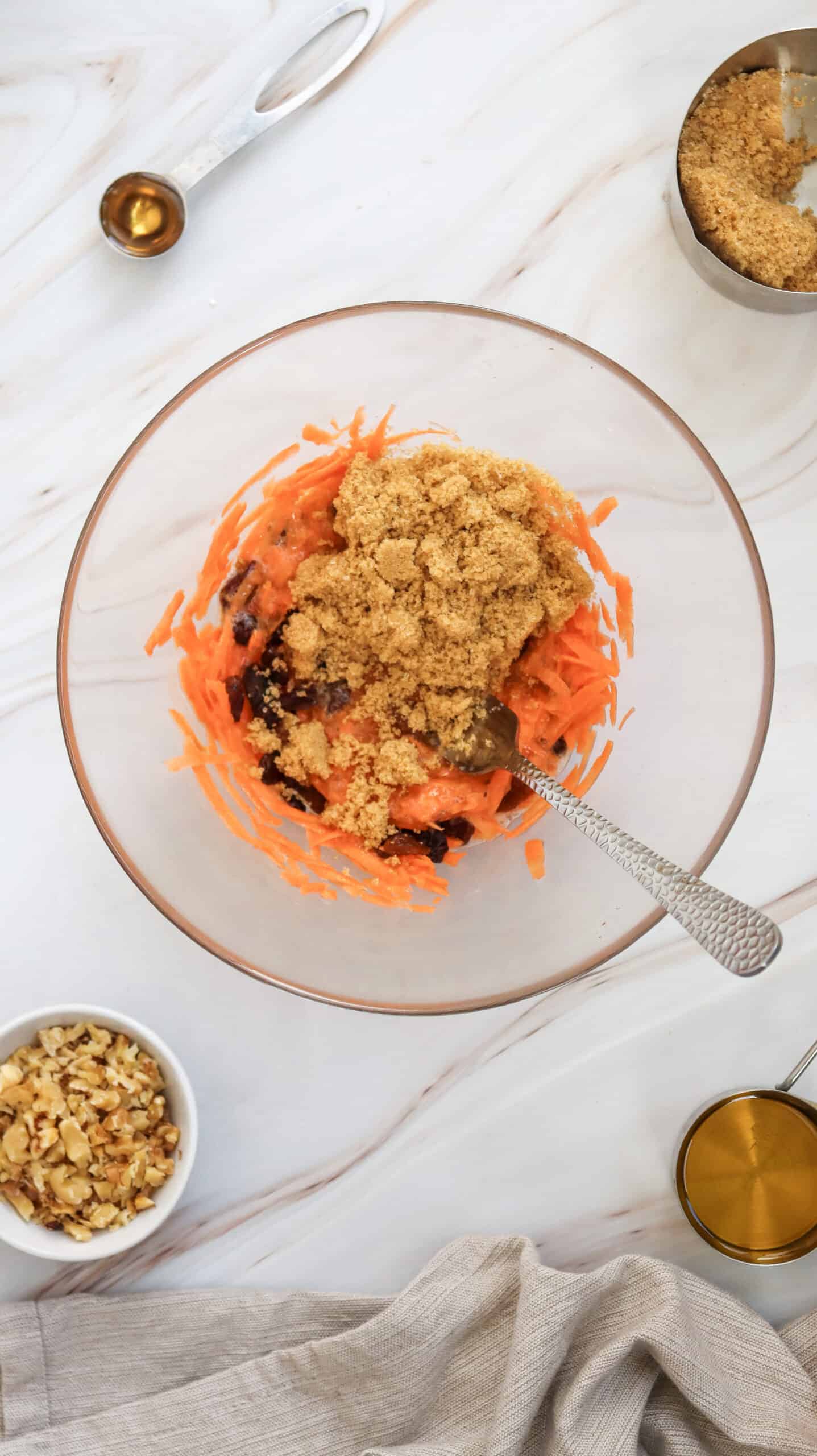 An overhead image of carrot cake muffins ingredients in a mixing bowl.