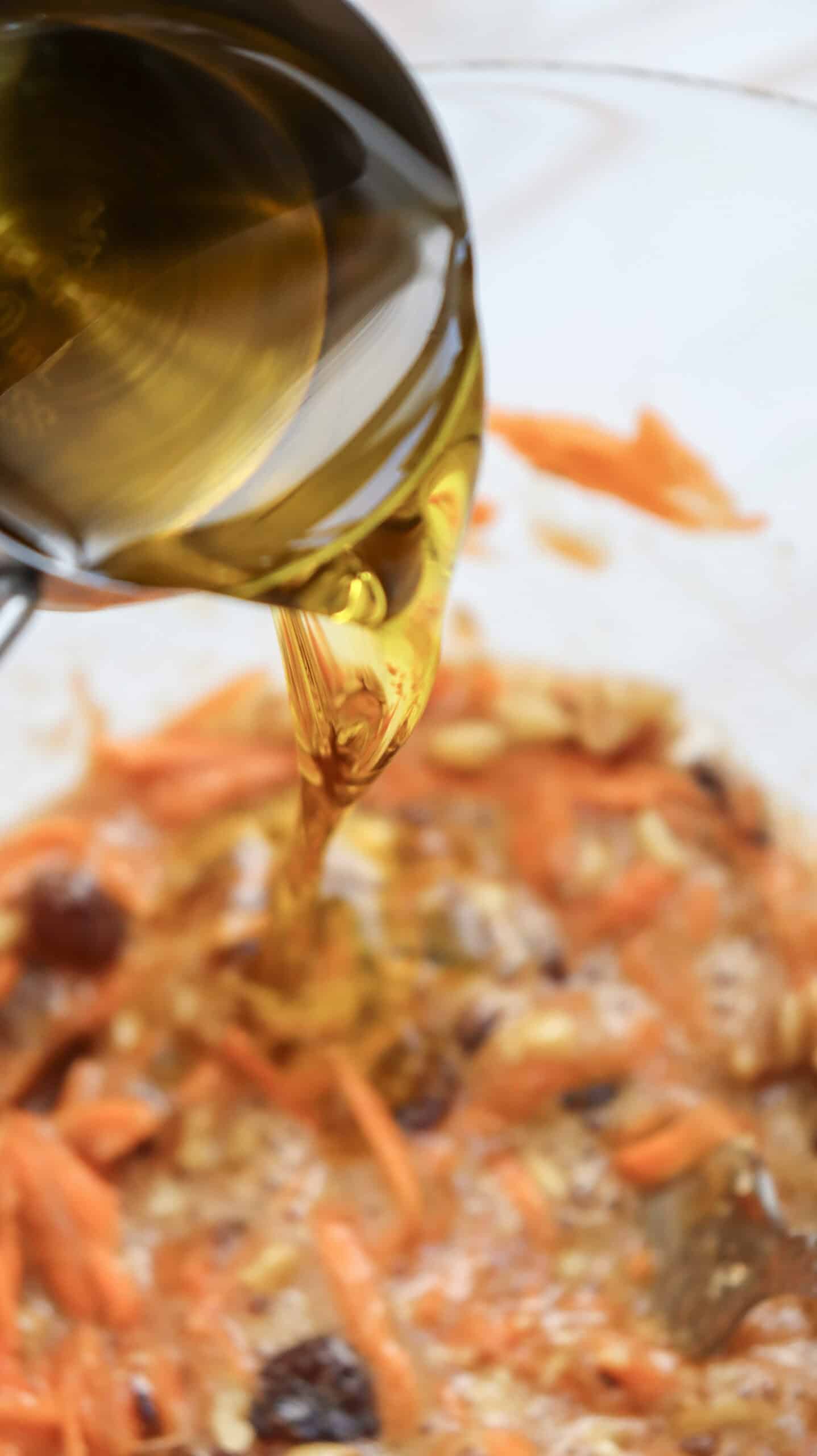 Close-up image of a brown syrup being poured in the batter.