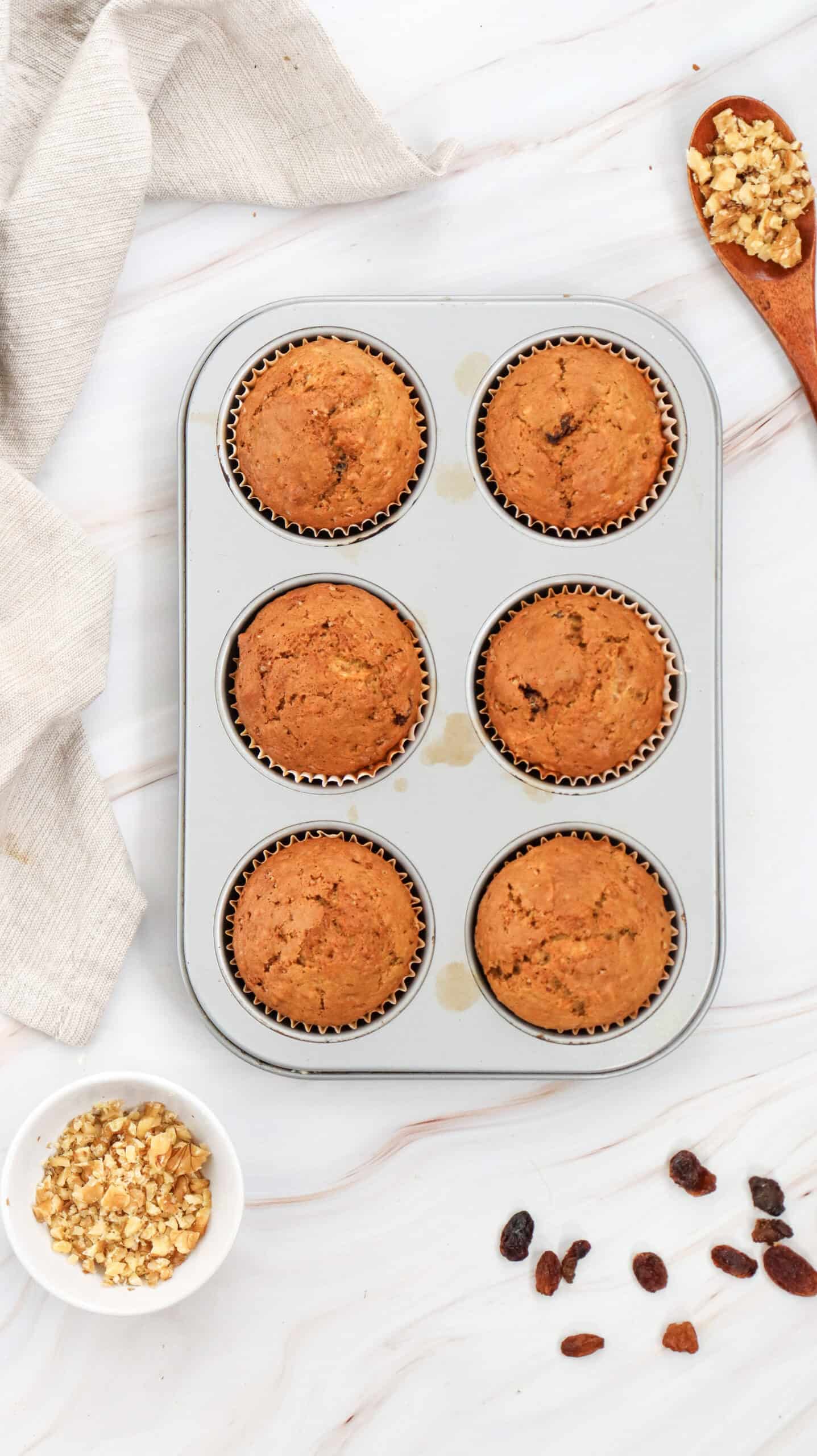 Top view of carrot cake muffins on a baking sheet.