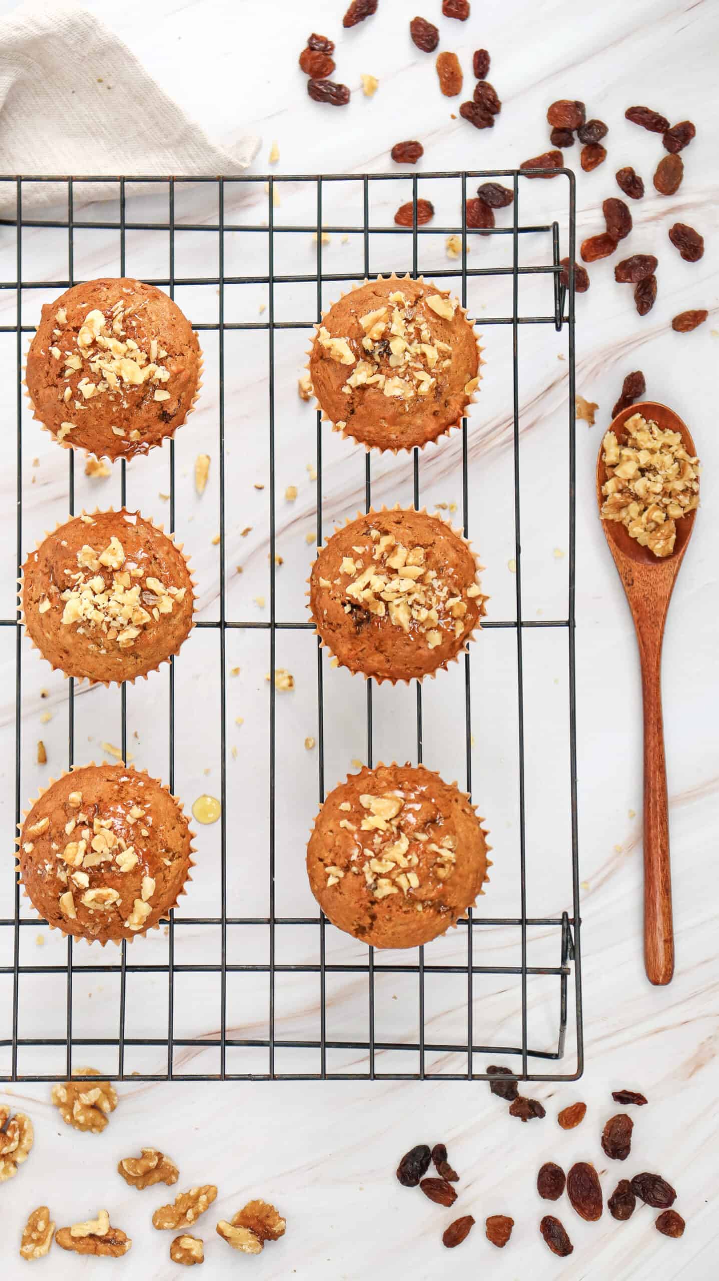 An overhead image of carrot cake muffins on a cooling rack.